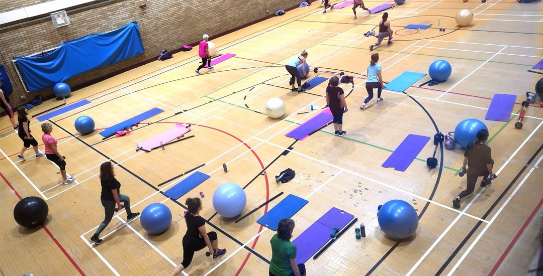 A photo of a fitness class taking place in the sports hall at Cowbridge leisure centre